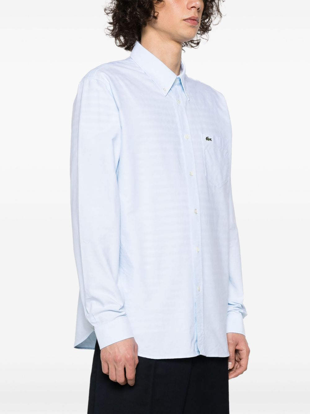 Blue shirts worn by a person, showing the shirts fit