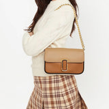 Tan bag carried by a person, showing the bag's fit