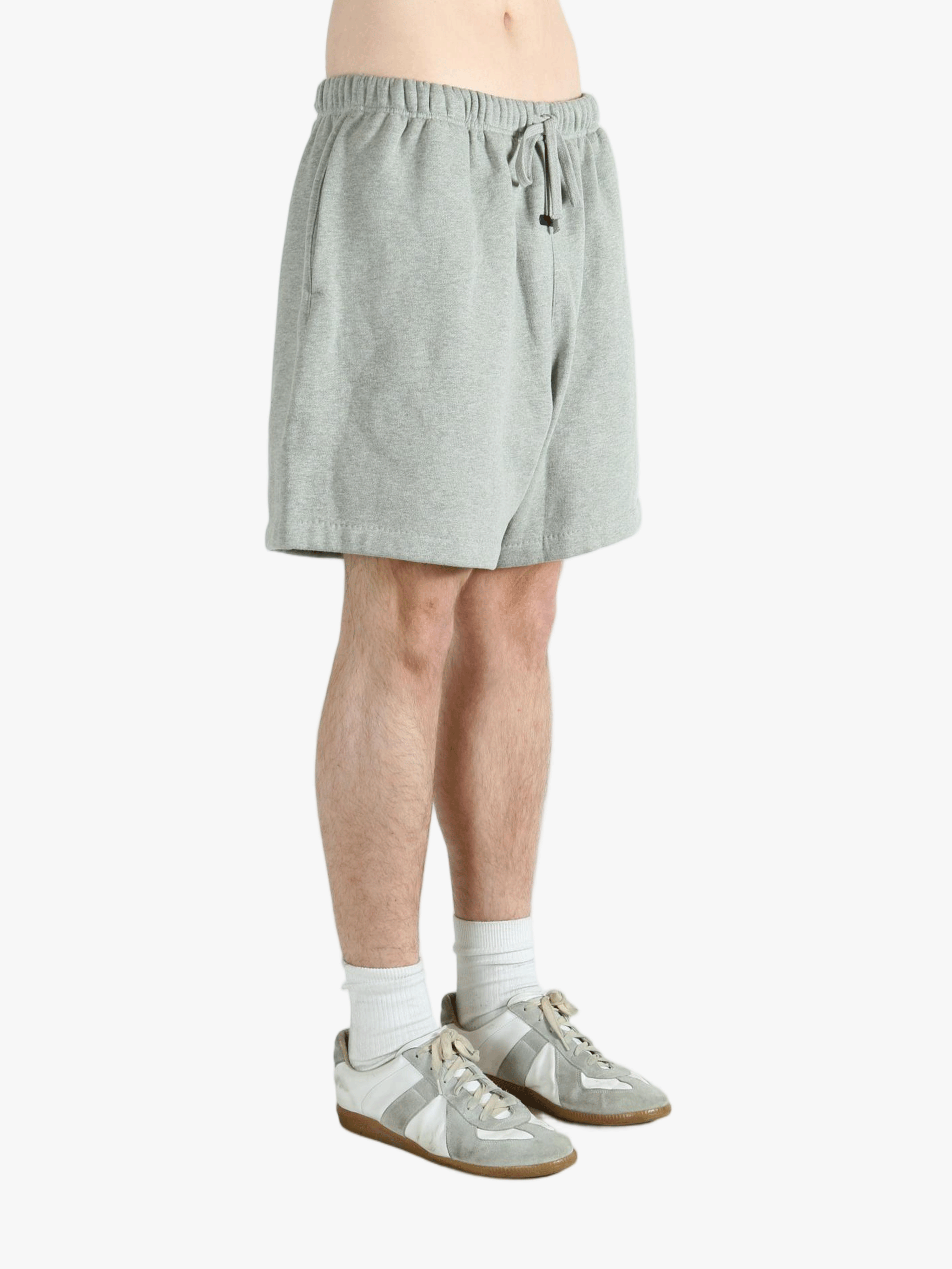 Gray shorts worn by a person, showing the short fit 