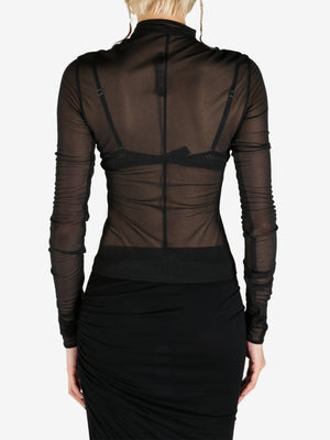Black coat worn by a person, showing the coat's fit
