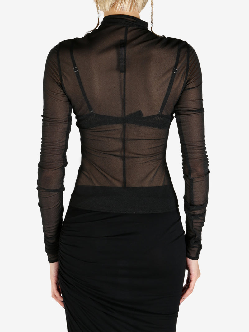Black coat worn by a person, showing the coat's fit