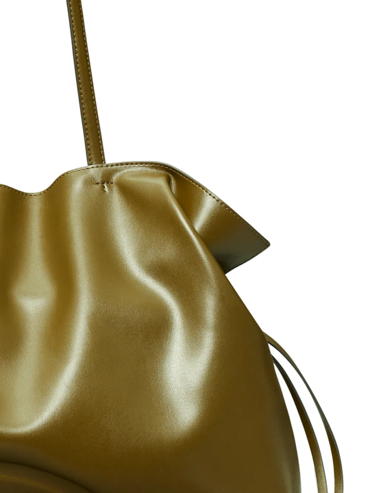Gold metallic handbag with drawstring on a white background