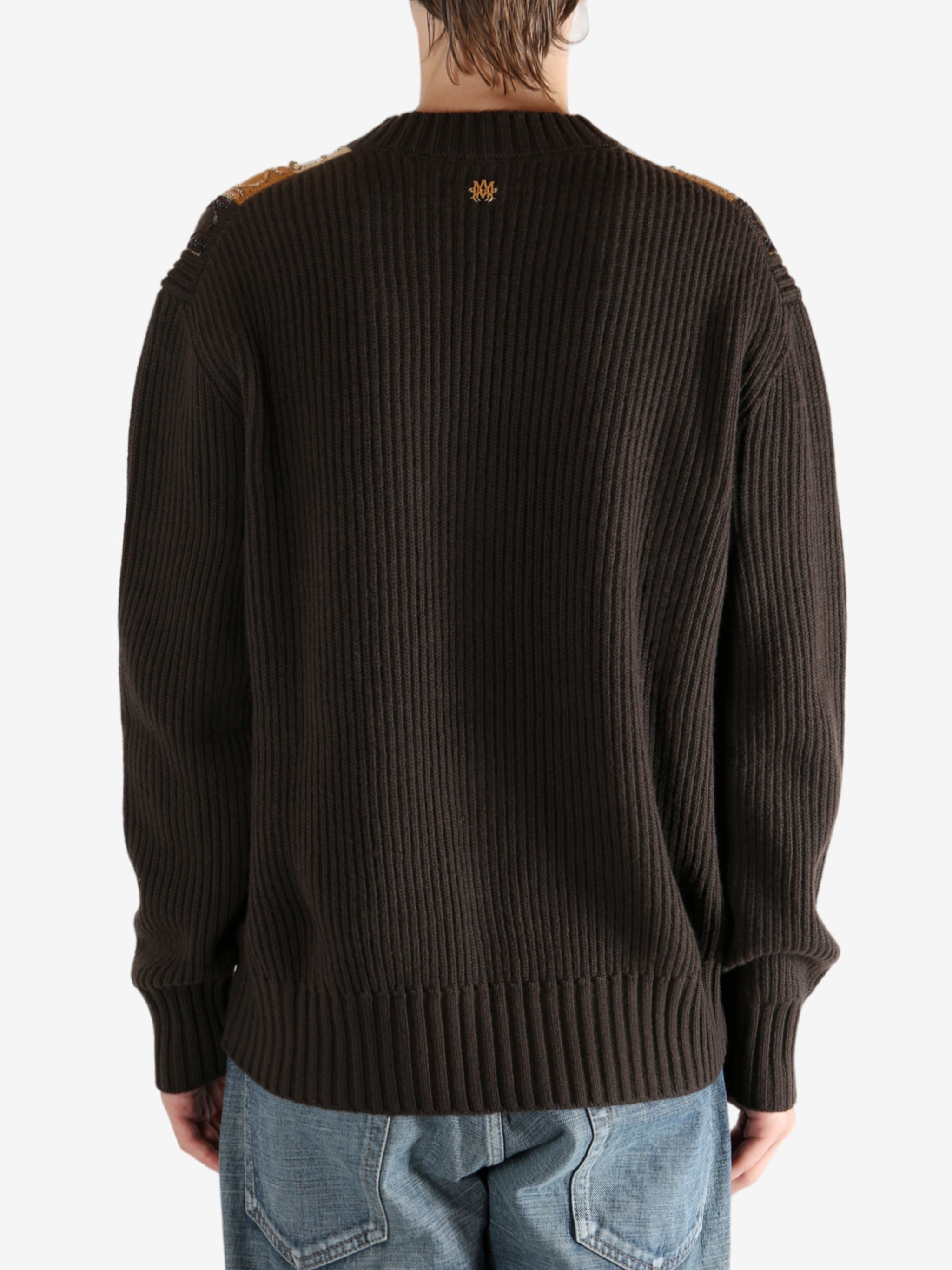 Brown sweater worn by a person, showing the sweater fit