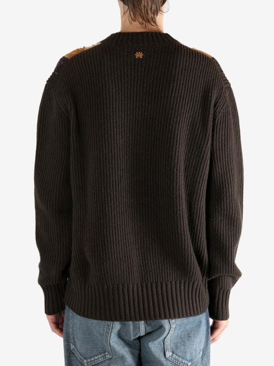 Brown sweater worn by a person, showing the sweater fit