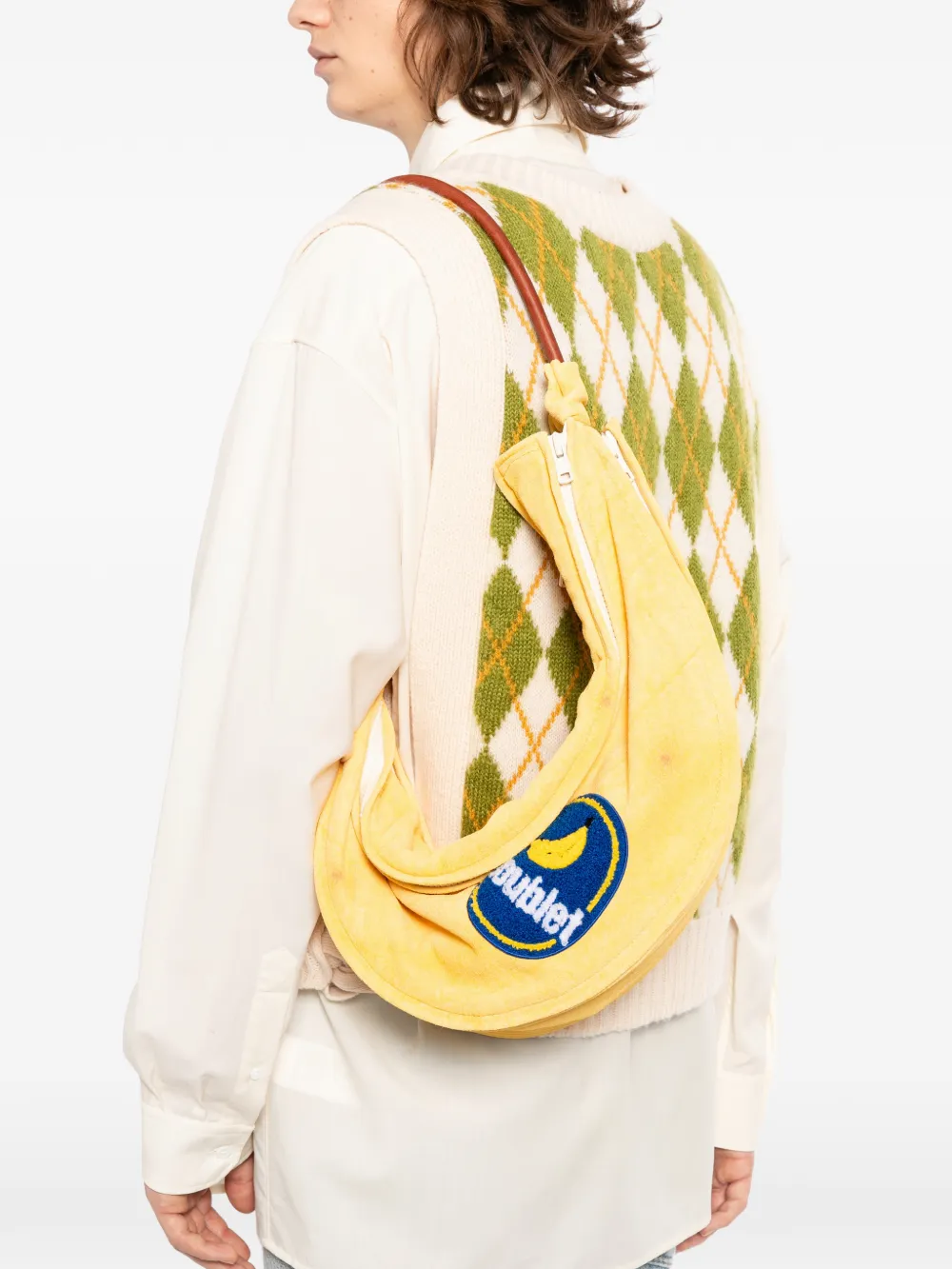 Yellow bag  worn by a person, showing the sweater 's fit