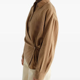Tan dress worn by a person, showing the dress fit