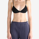 Black bra worn by a person, showing the bra's fit