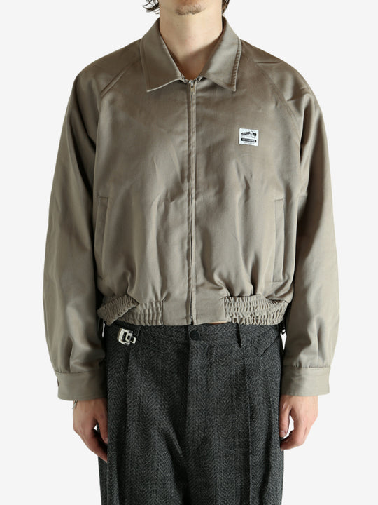 Tan jacket worn by a person, showing the jacket's fit