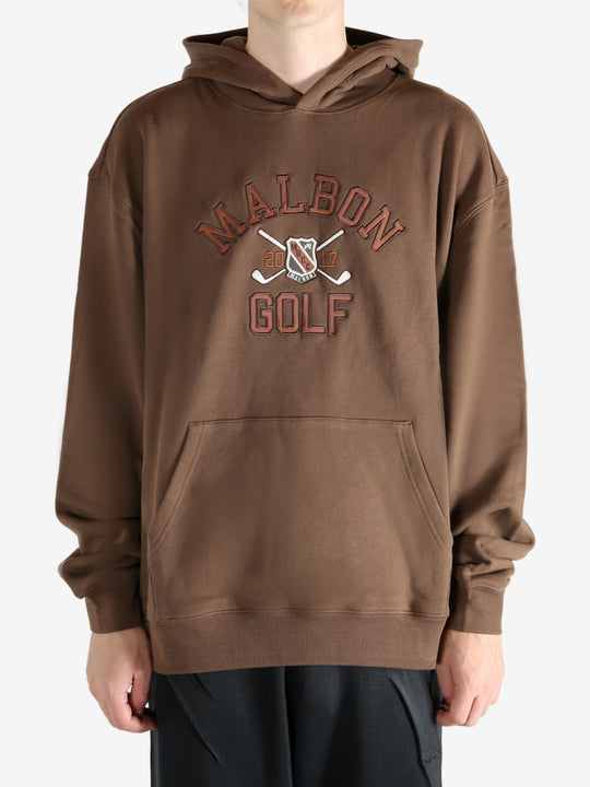 Brown hoodie worn by a person, showing the hoodie's fit