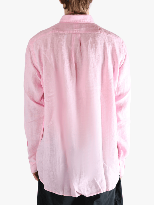 Pink shirt worn by a person, showing the shirt's fit