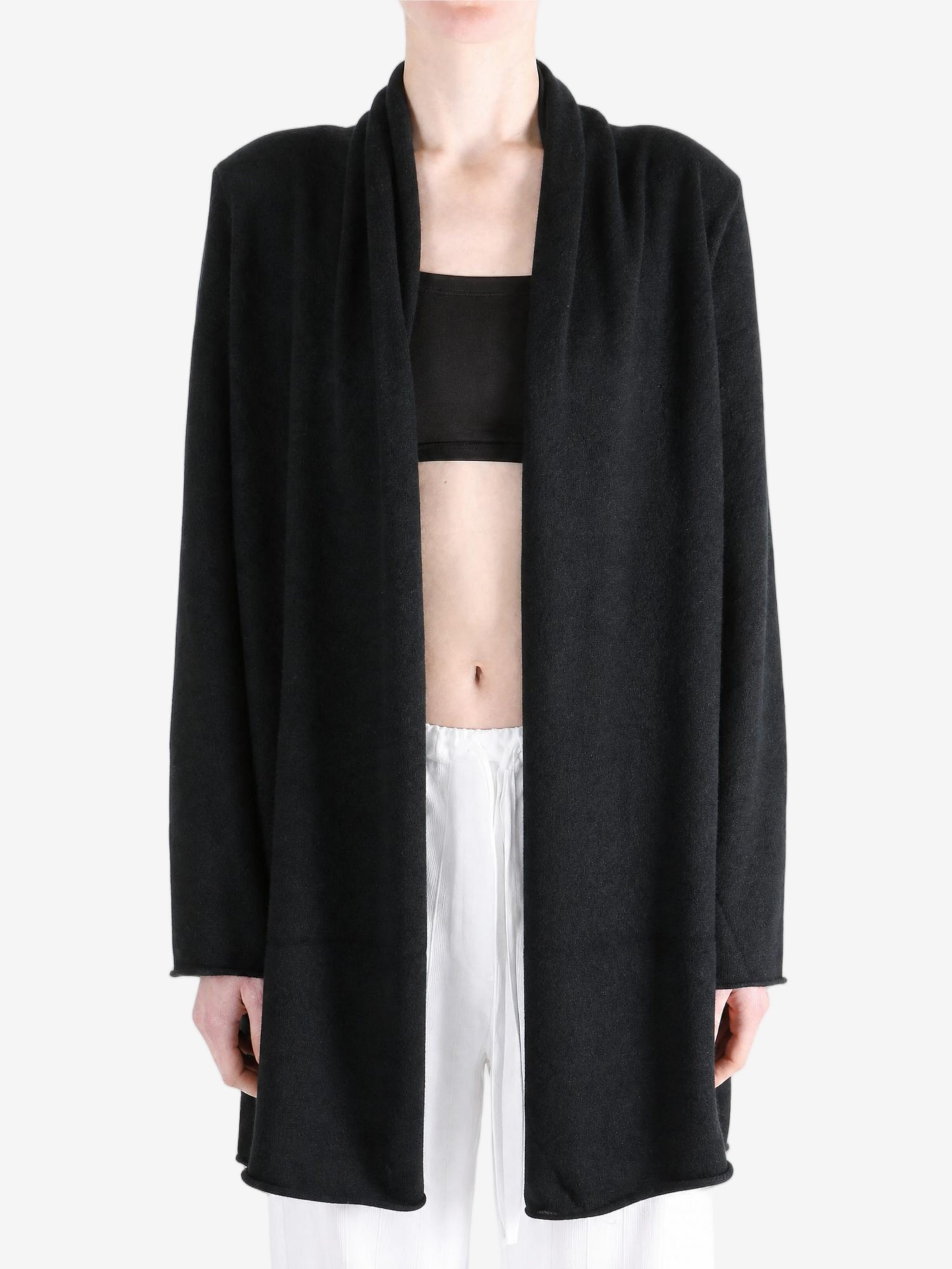 Black knitwear worn by a person, showing the knitwear fit