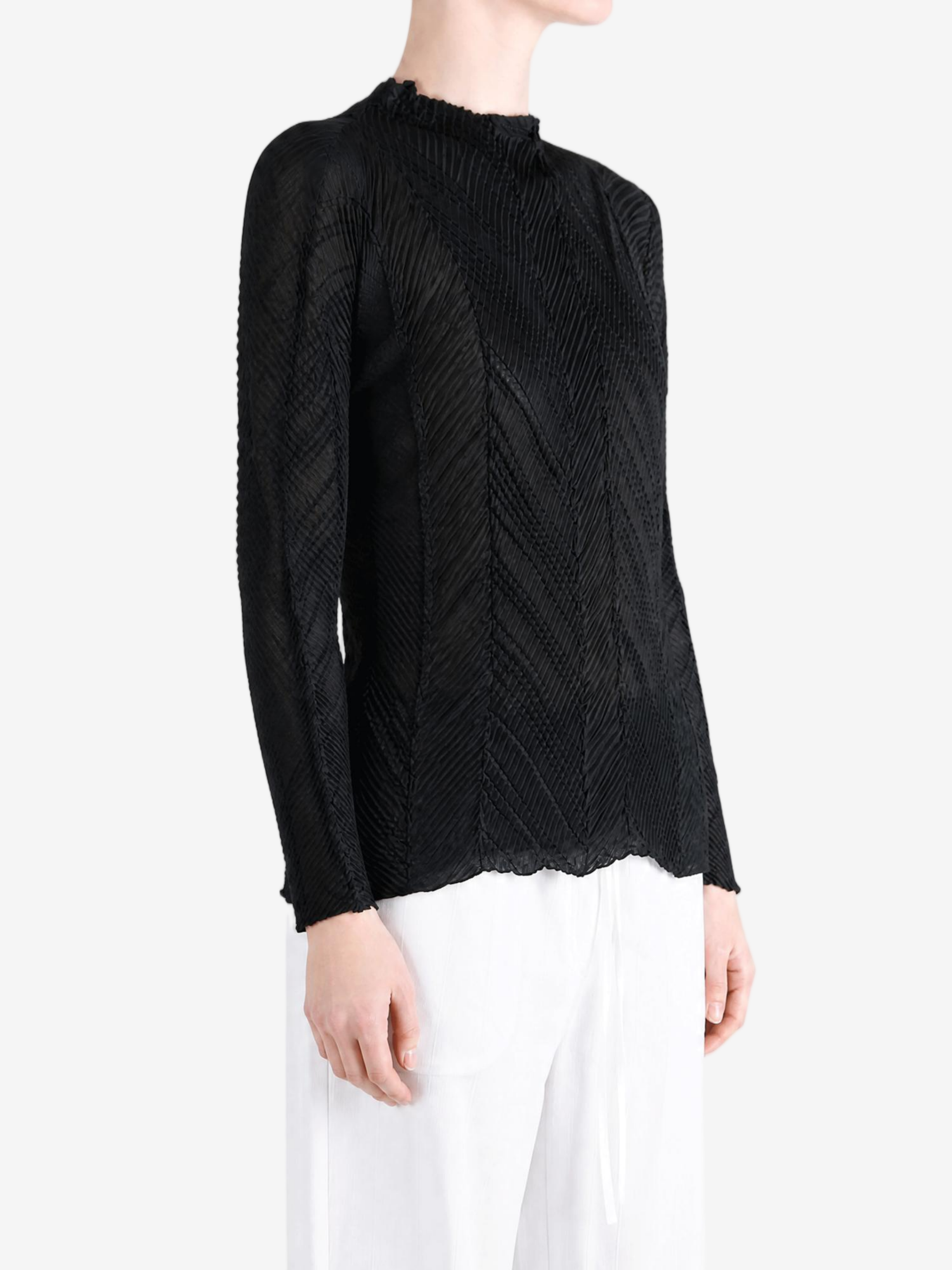 Black shirt worn by a person, showing the shirt fit