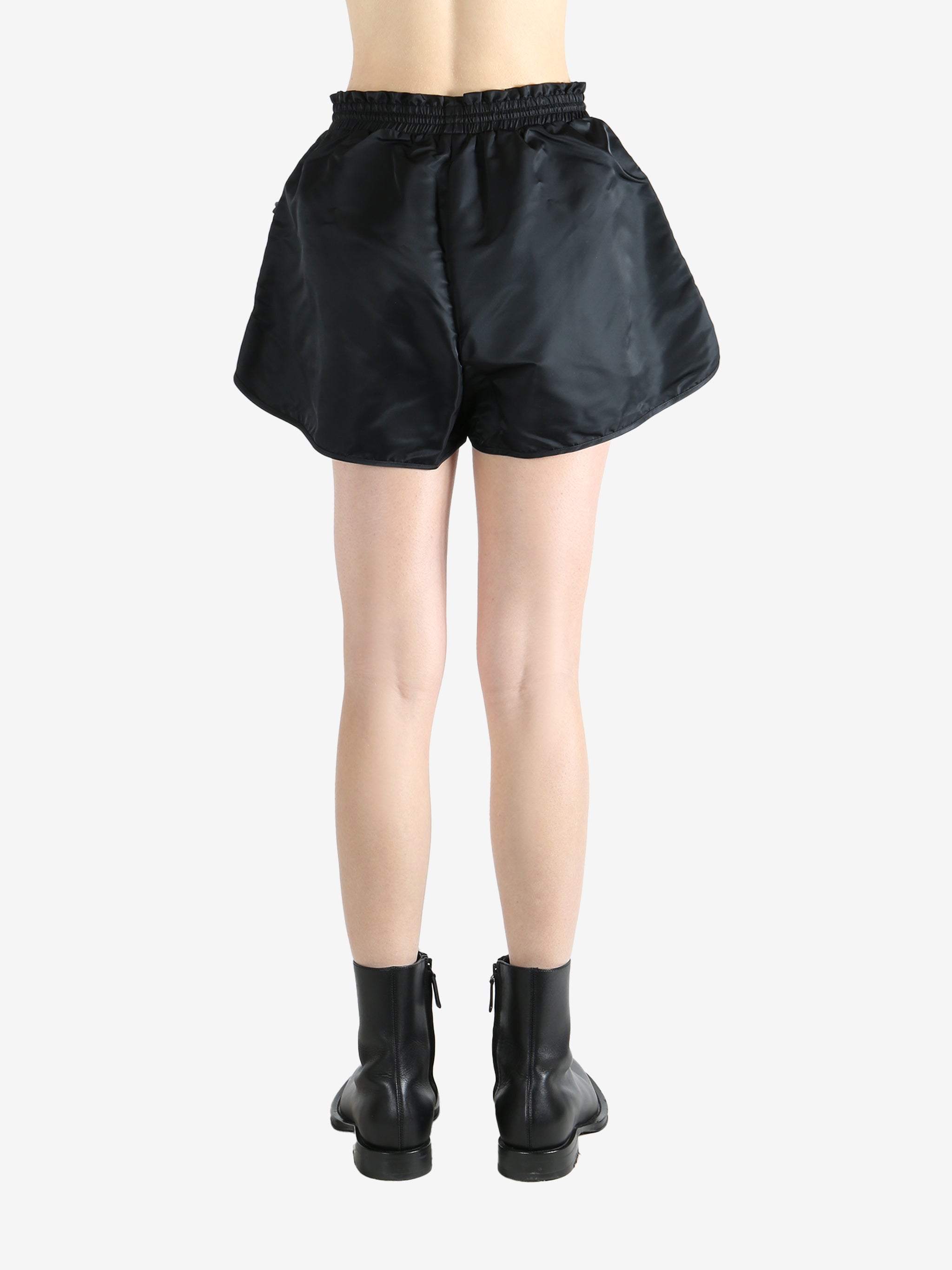 Black shorts worn by a person, showing the short's fit
