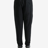 Black pants worn by a person, showing the pants's fit