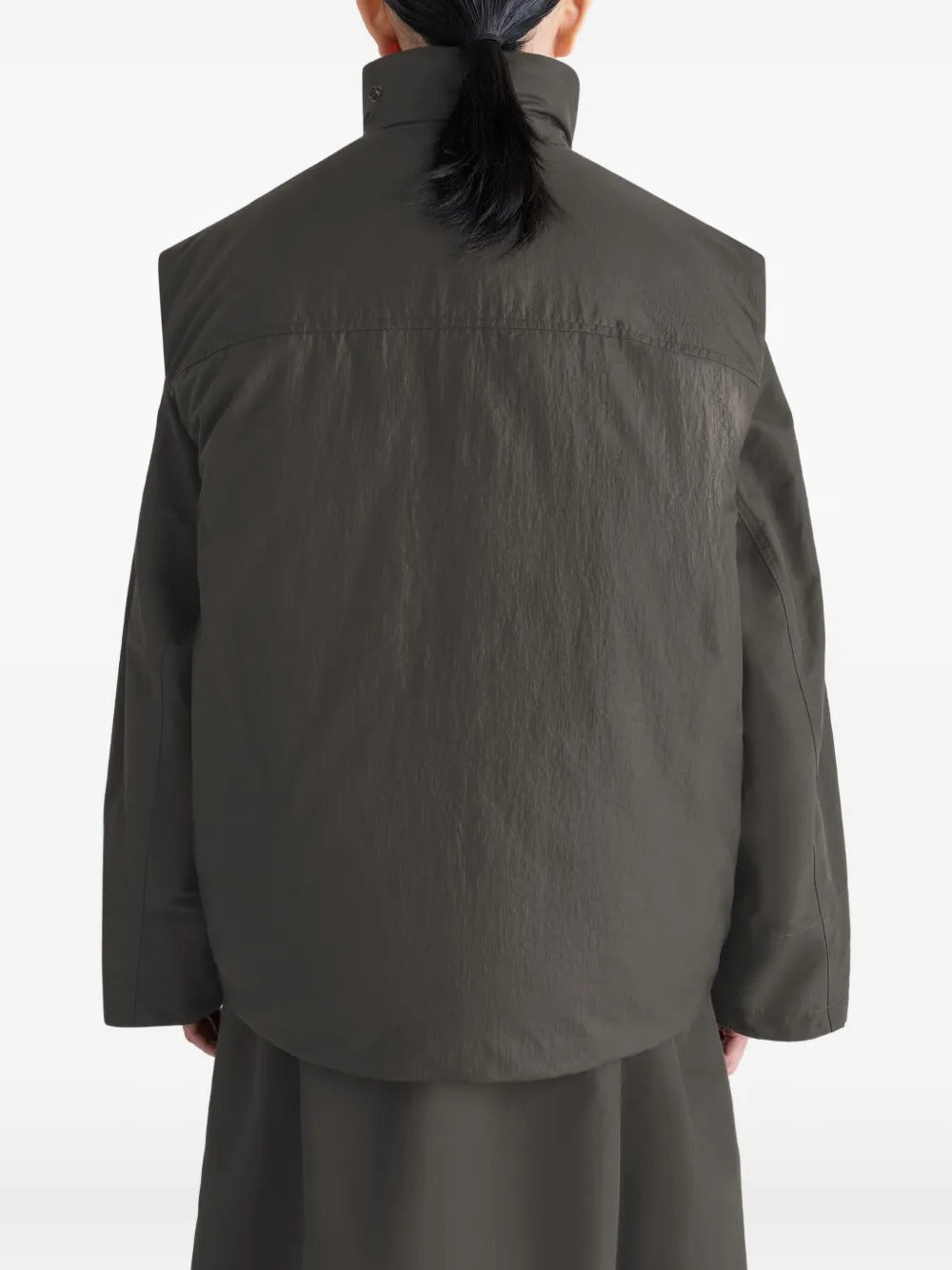 Brown coat worn by a person, showing the coat's fit