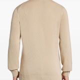 Tan sweater worn by a person, showing the sweater fit