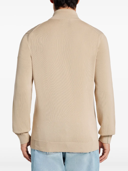 Tan sweater worn by a person, showing the sweater fit