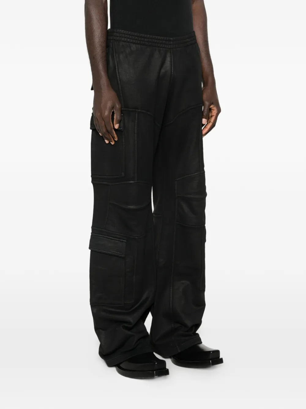 Black pants worn by a person, showing the pants fit