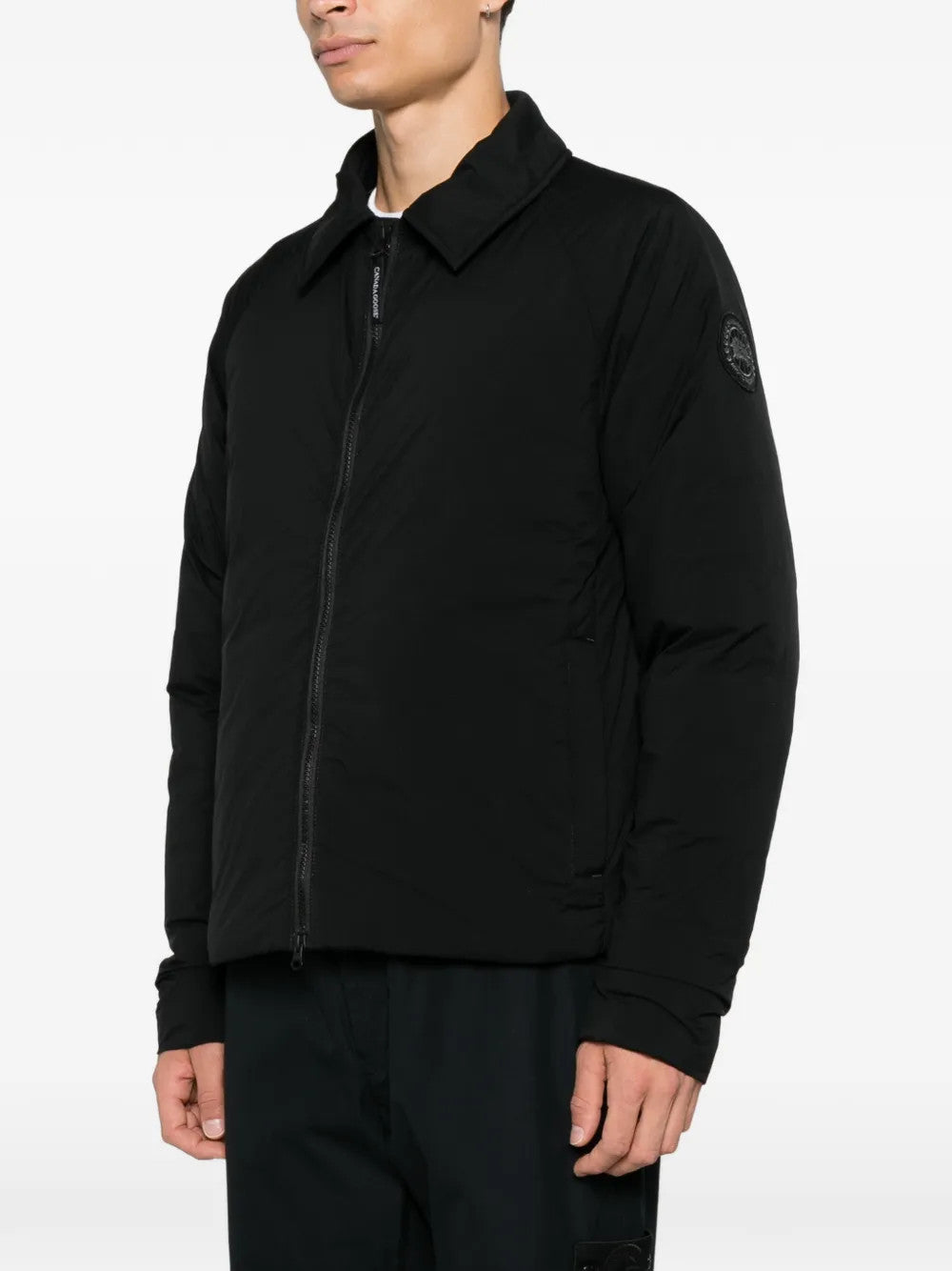 Black jacket worn by a person, showing the jacket fit