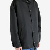 Black jacket worn by a person, showing the jacket fit