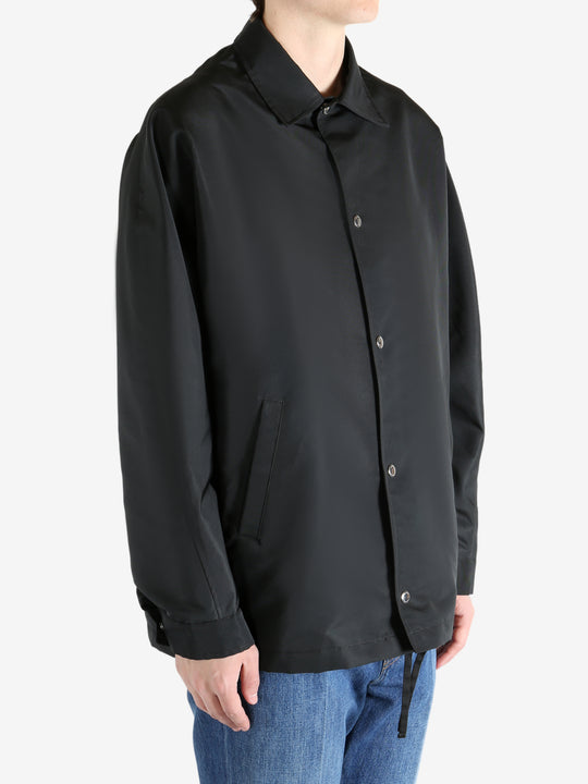 Black jacket worn by a person, showing the jacket fit