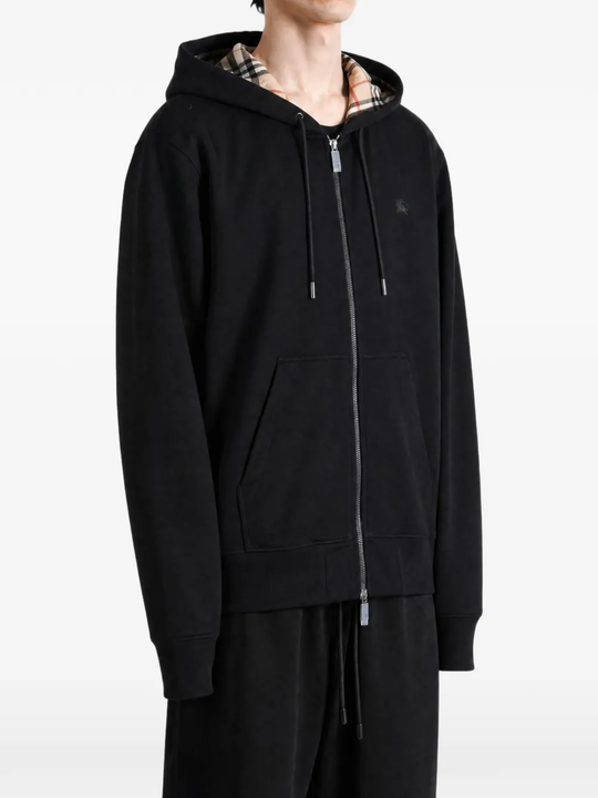 Black top worn by a person, showing the top fit