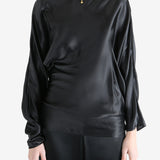 Black top worn by a person, showing the top's fit