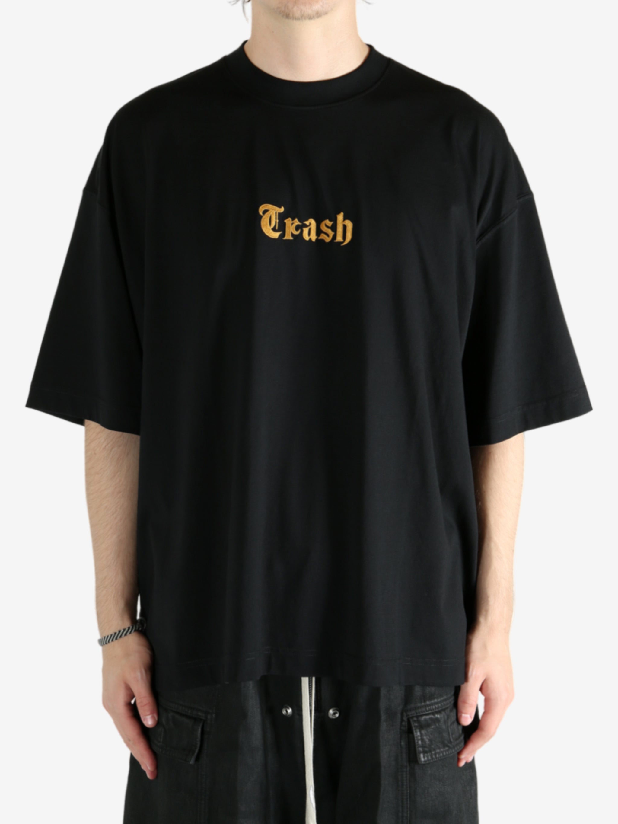 Black t-shirt worn by a person, showing the shirt's fit