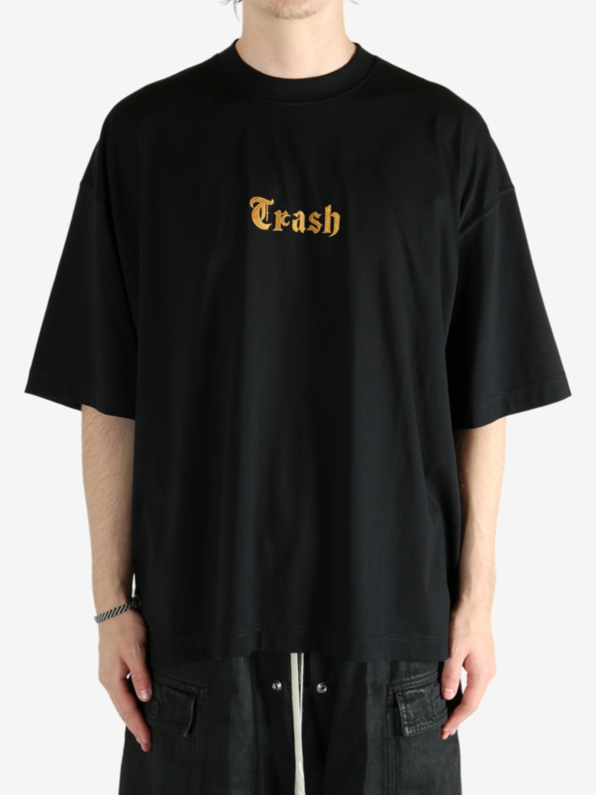 Black t-shirt worn by a person, showing the shirt's fit