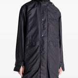 Close up of the black coat, showing texture of the nylon fabric