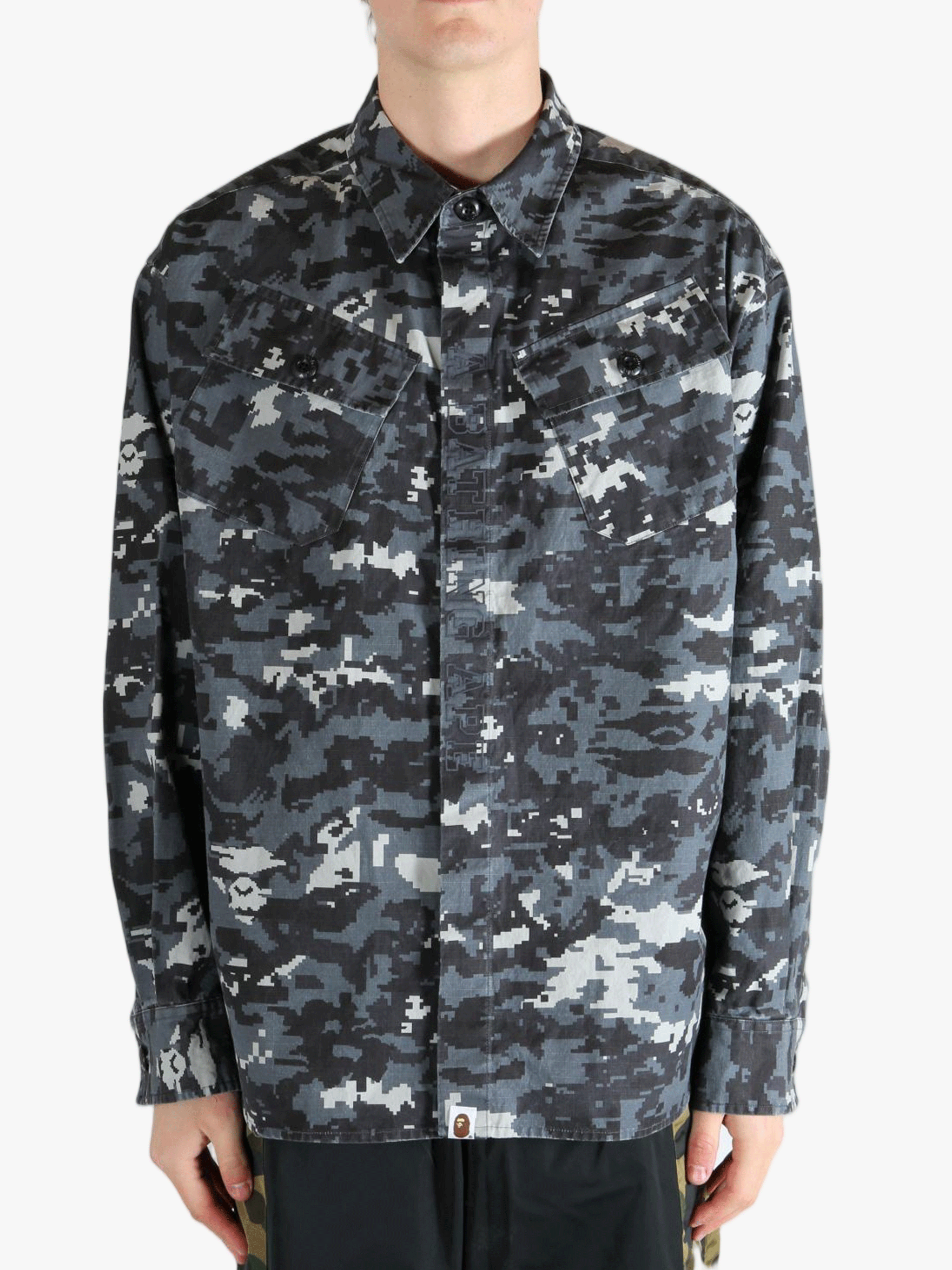 Black shirt worn by a person, showing the fit