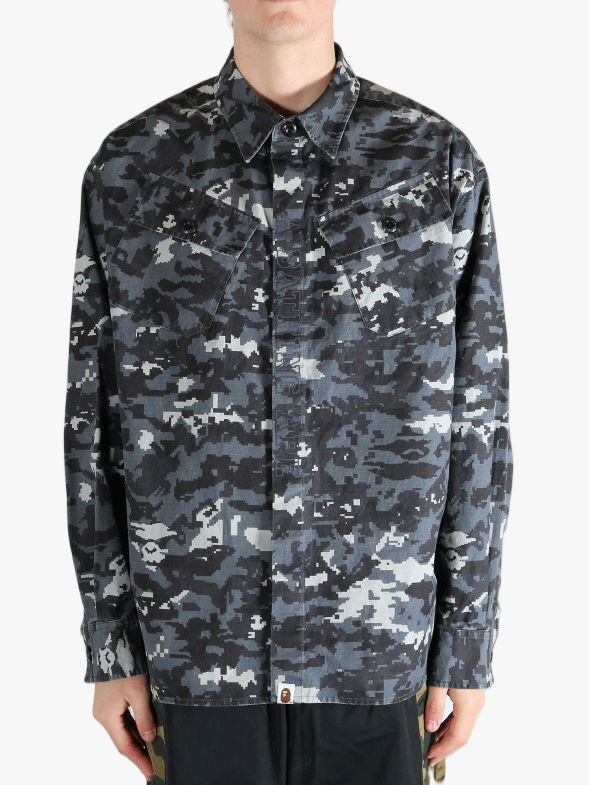 Black shirt worn by a person, showing the fit