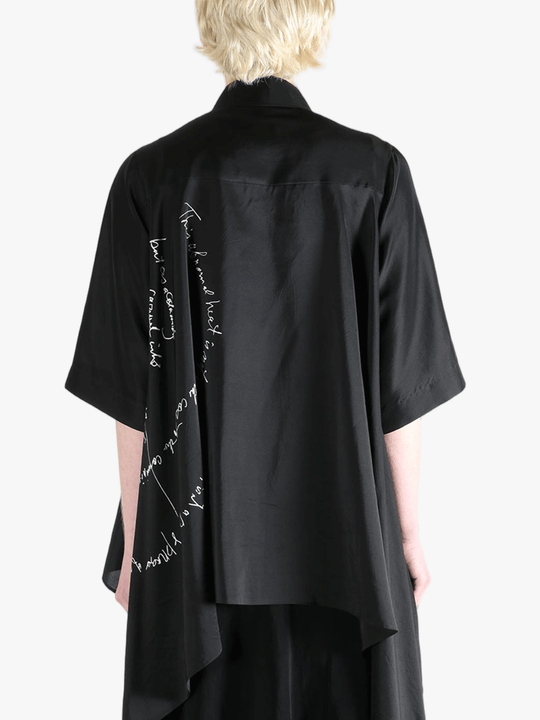 Black shirt worn by a person, showing the shirt's fit