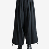 Black pants worn by a person, showing the pants fit