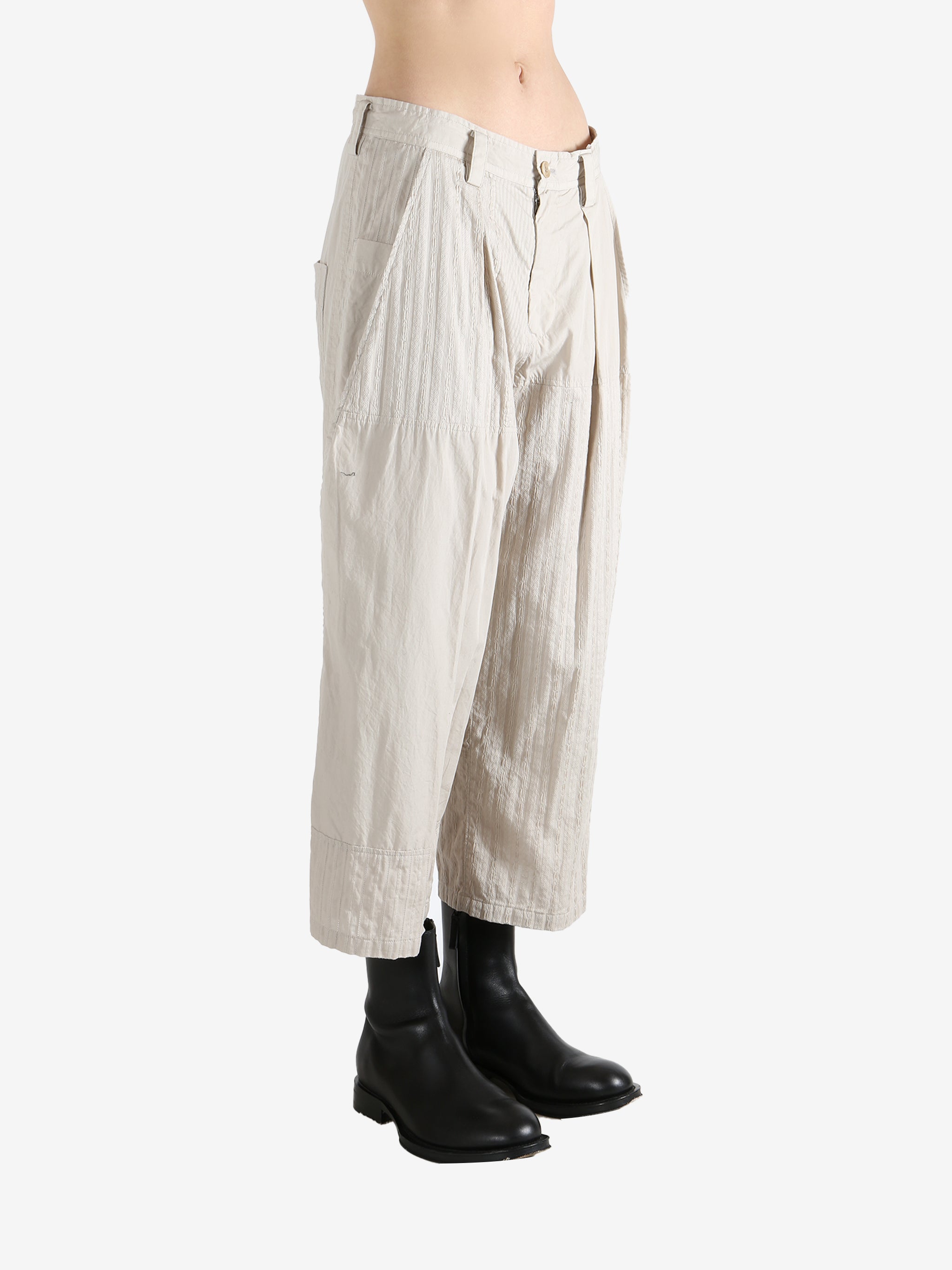 White pants worn by a person, showing the pants fit