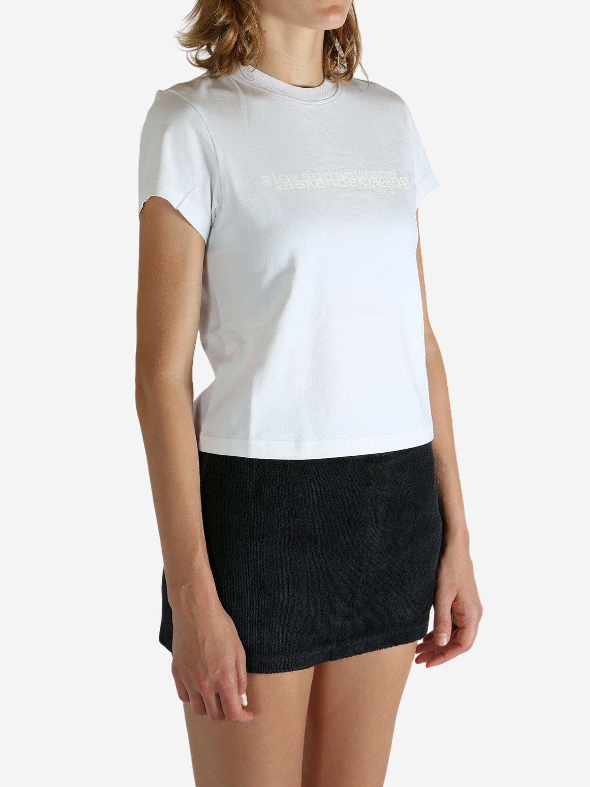 White t-shirt worn by a person, showing the shirt's fit