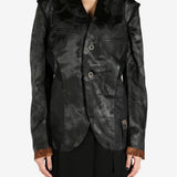 Black jacket worn by a person, showing the jacket's fit