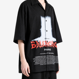 Black shirt worn by a person, showing the shirt fit