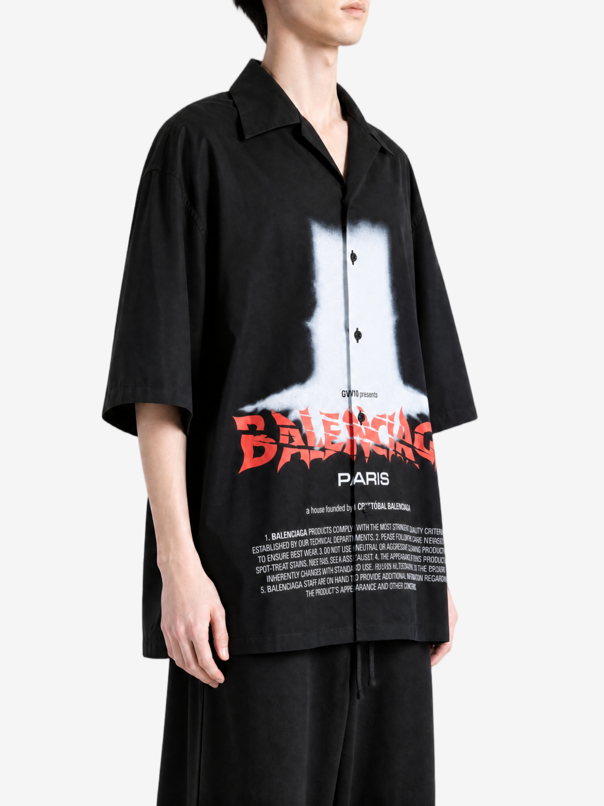 Black shirt worn by a person, showing the shirt fit