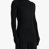 Black knitwear worn by a person, showing the knitwear fit