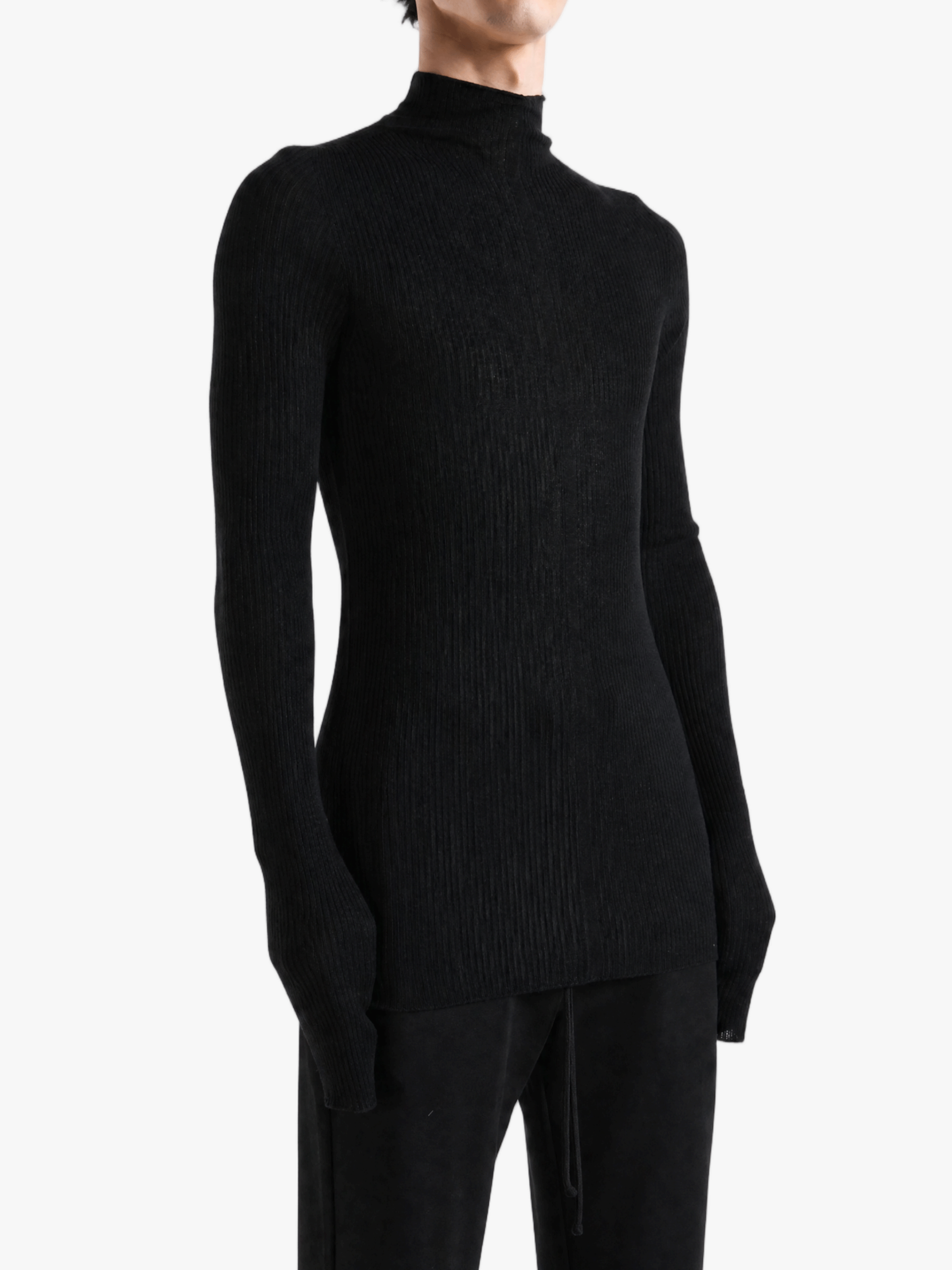 Black knitwear worn by a person, showing the knitwear fit