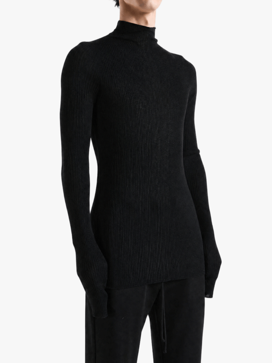 Black knitwear worn by a person, showing the knitwear fit