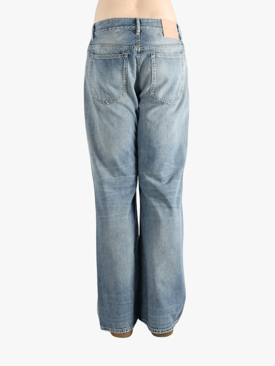 Blue jean worn by a person, showing the cow leather fit