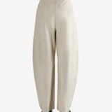 White pants worn by a person, showing the pants' fit