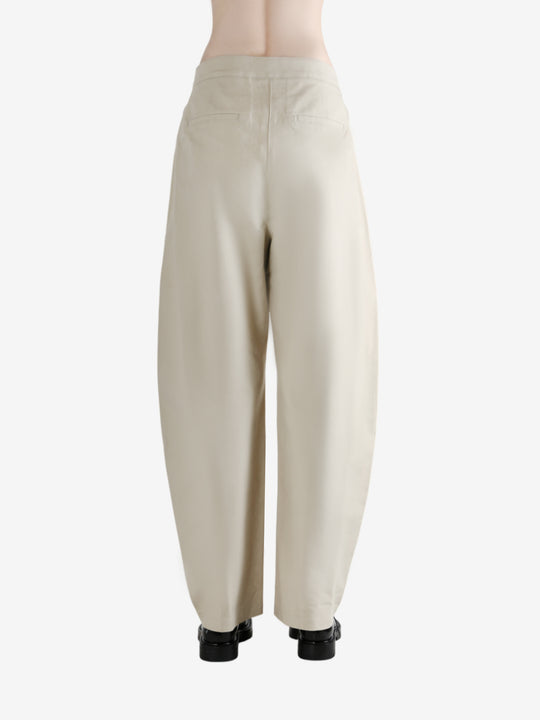 White pants worn by a person, showing the pants' fit