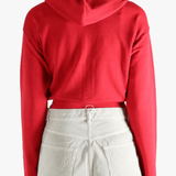 Red hoodie worn by a person, showing the hoodie's fit