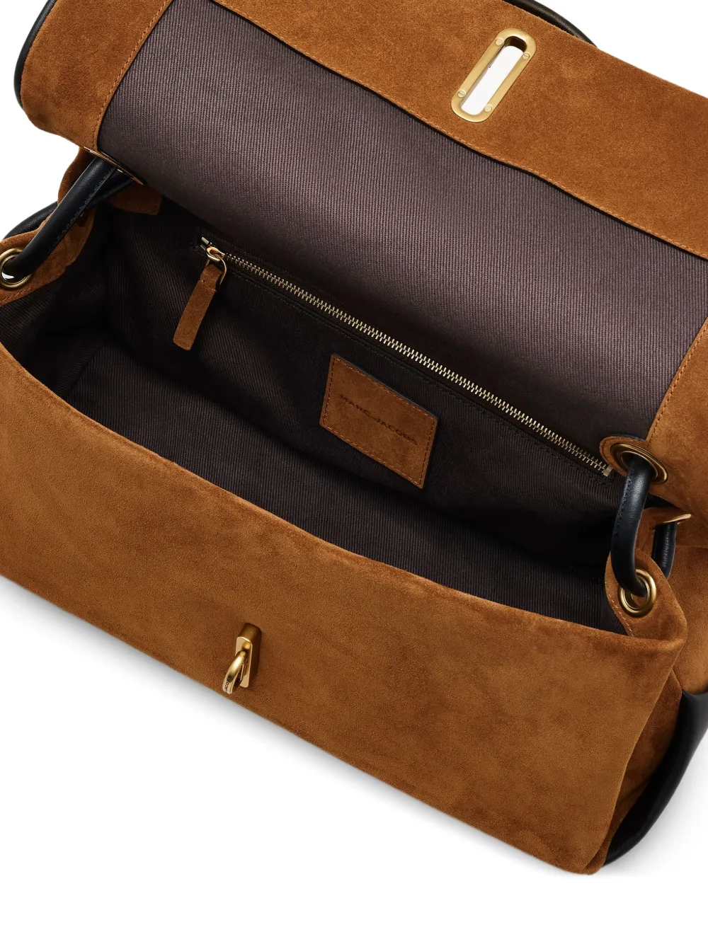 Close up of brown bags, showing texture of the suede cow leather fabric