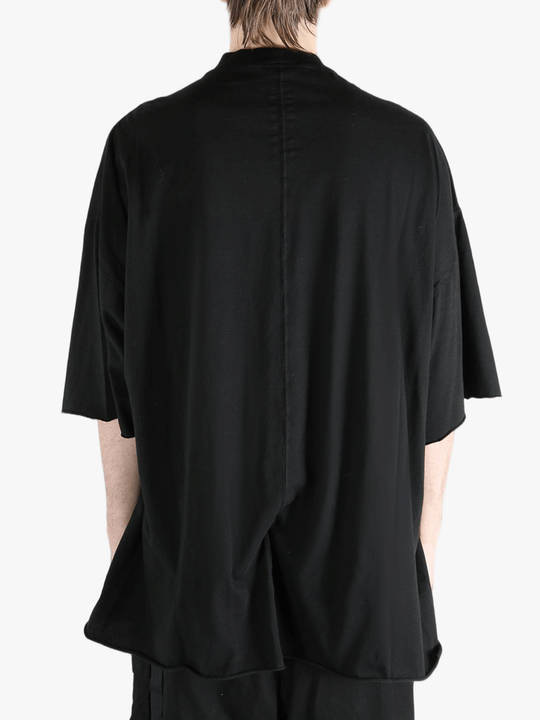 Black t-shirts worn by a person, showing the t-shirts fit