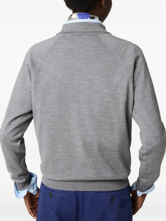Grey knitwear  worn by a person, showing the knitwear's fit