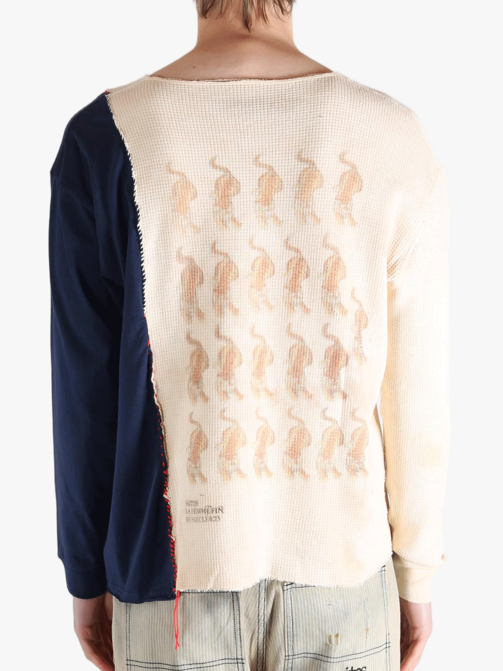 White knitwear worn by a person, showing the knitwears fit